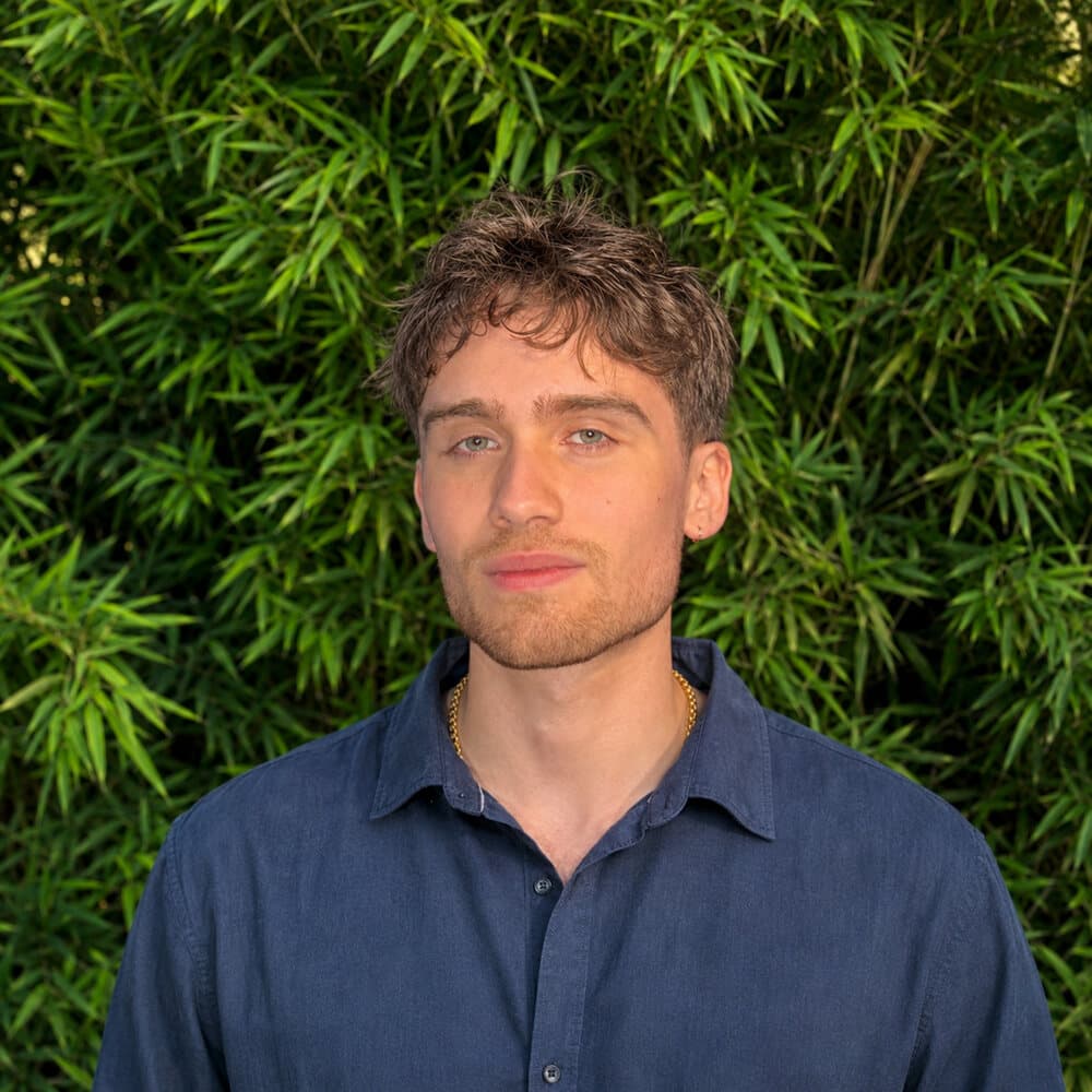 Rafael Aslanian photographed against bamboo